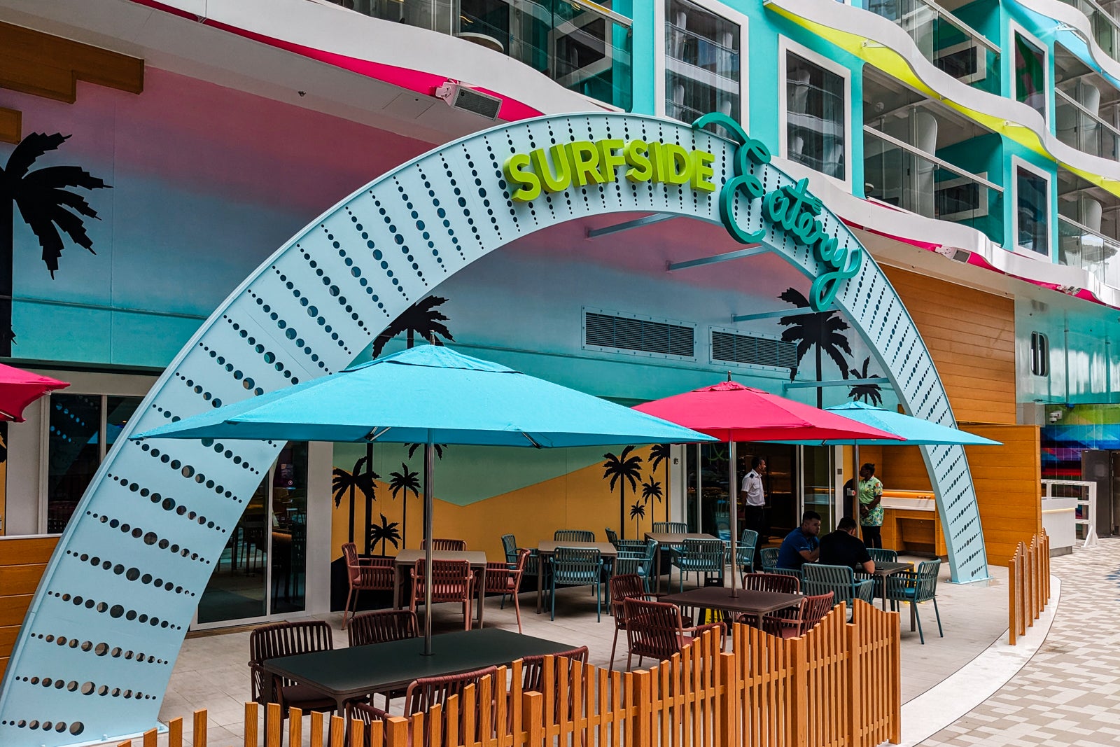 Archway reading Surfside Eatery over outdoor seating by restaurant entrance on Icon of the Seas