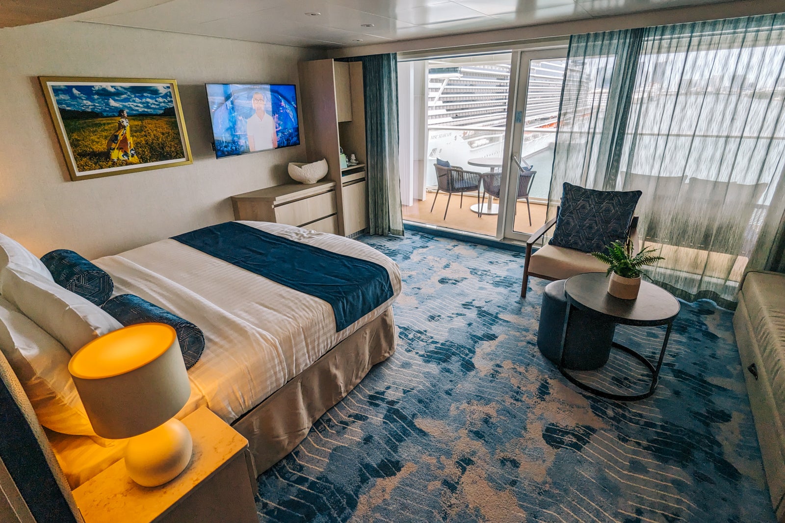 A cruise ship cabin with the bed facing the balcony