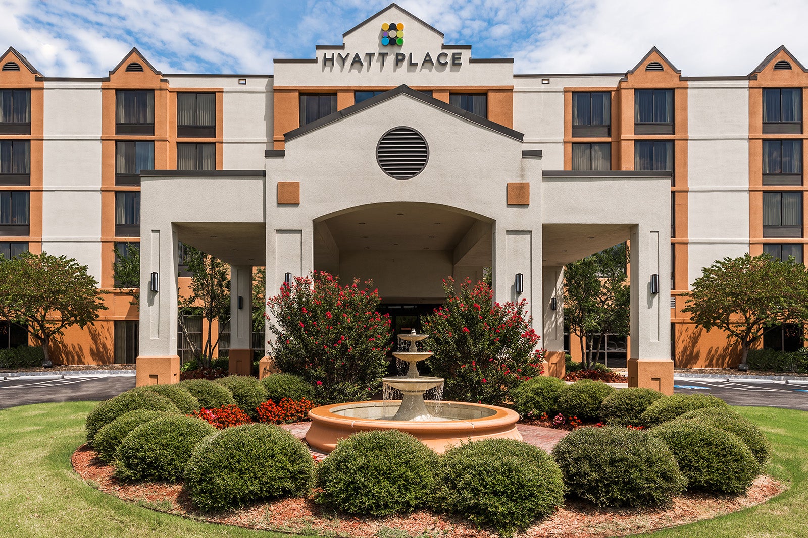 Hyatt Place entrance behind fountain and garden