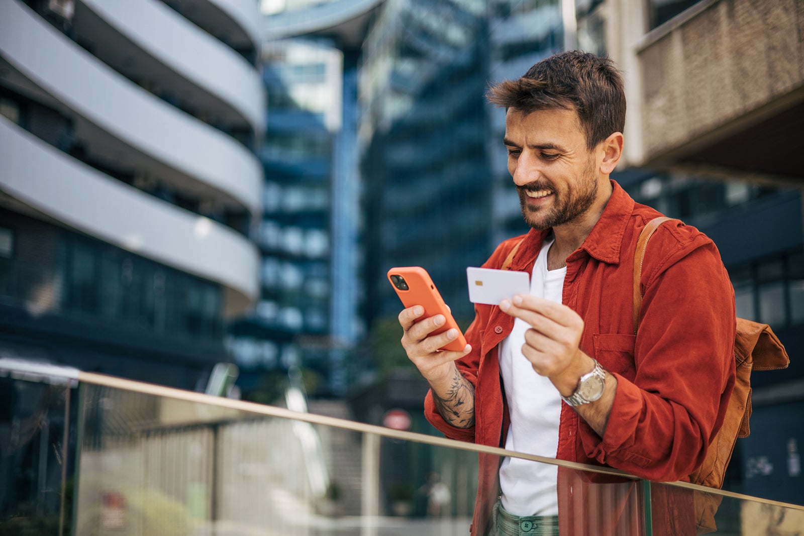 Man using a credit card on his phone