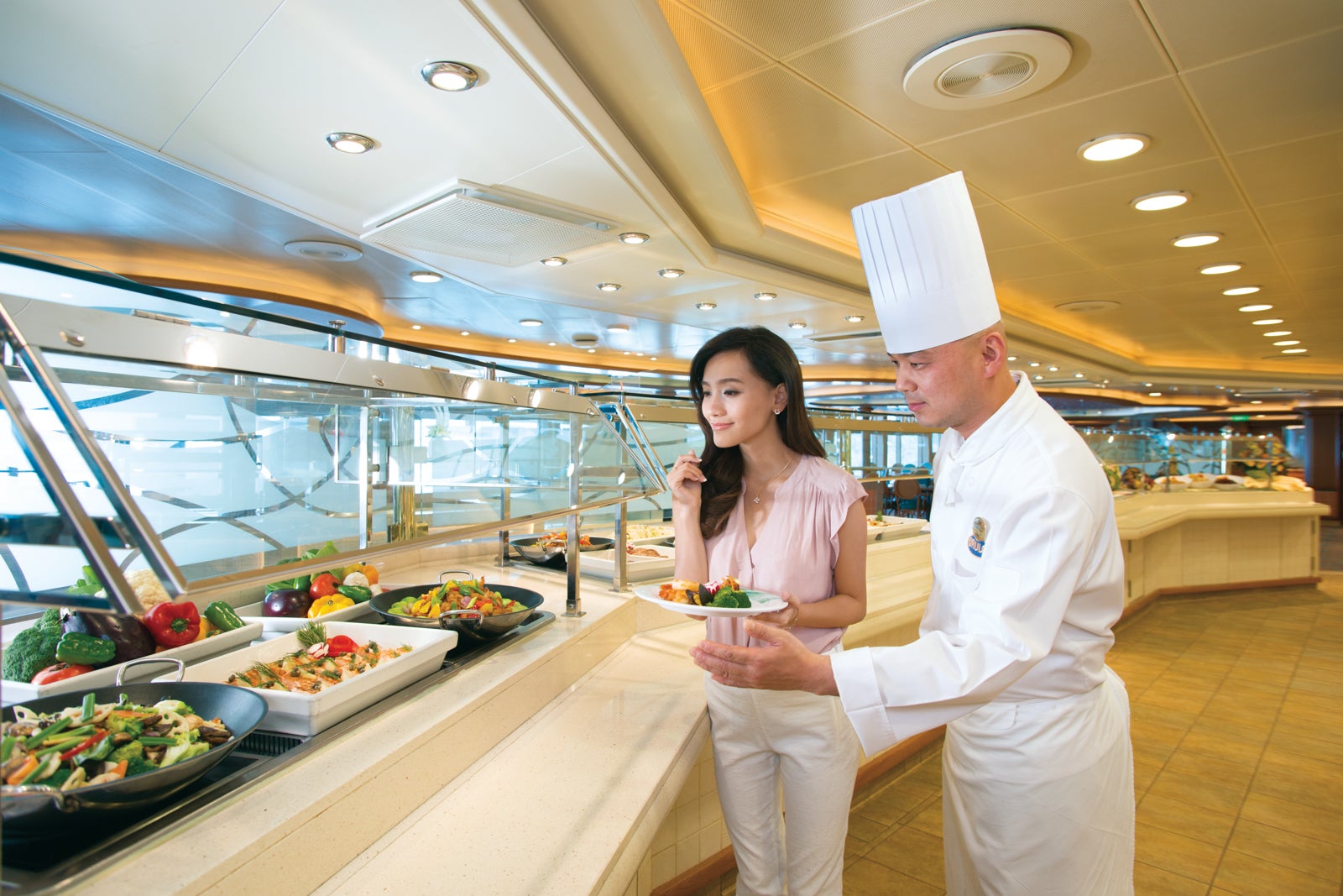 Chef helping woman at cruise ship buffet