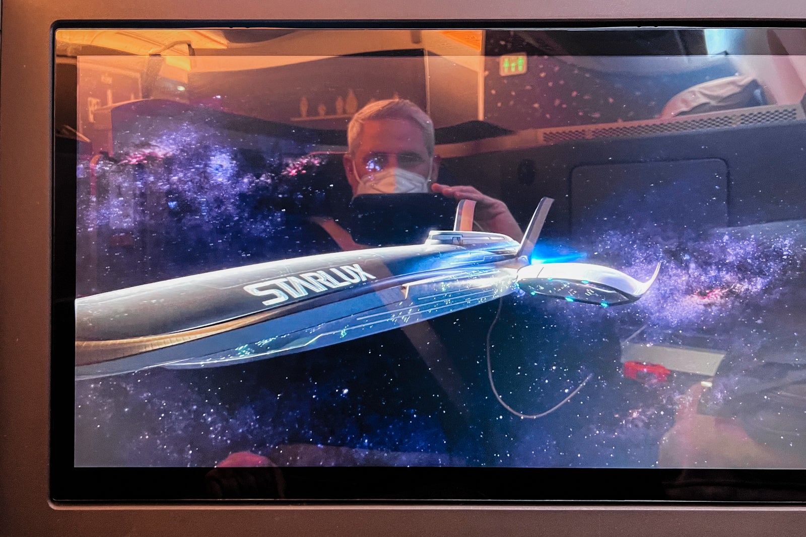 Starlux safety video playing on a 4K screen.