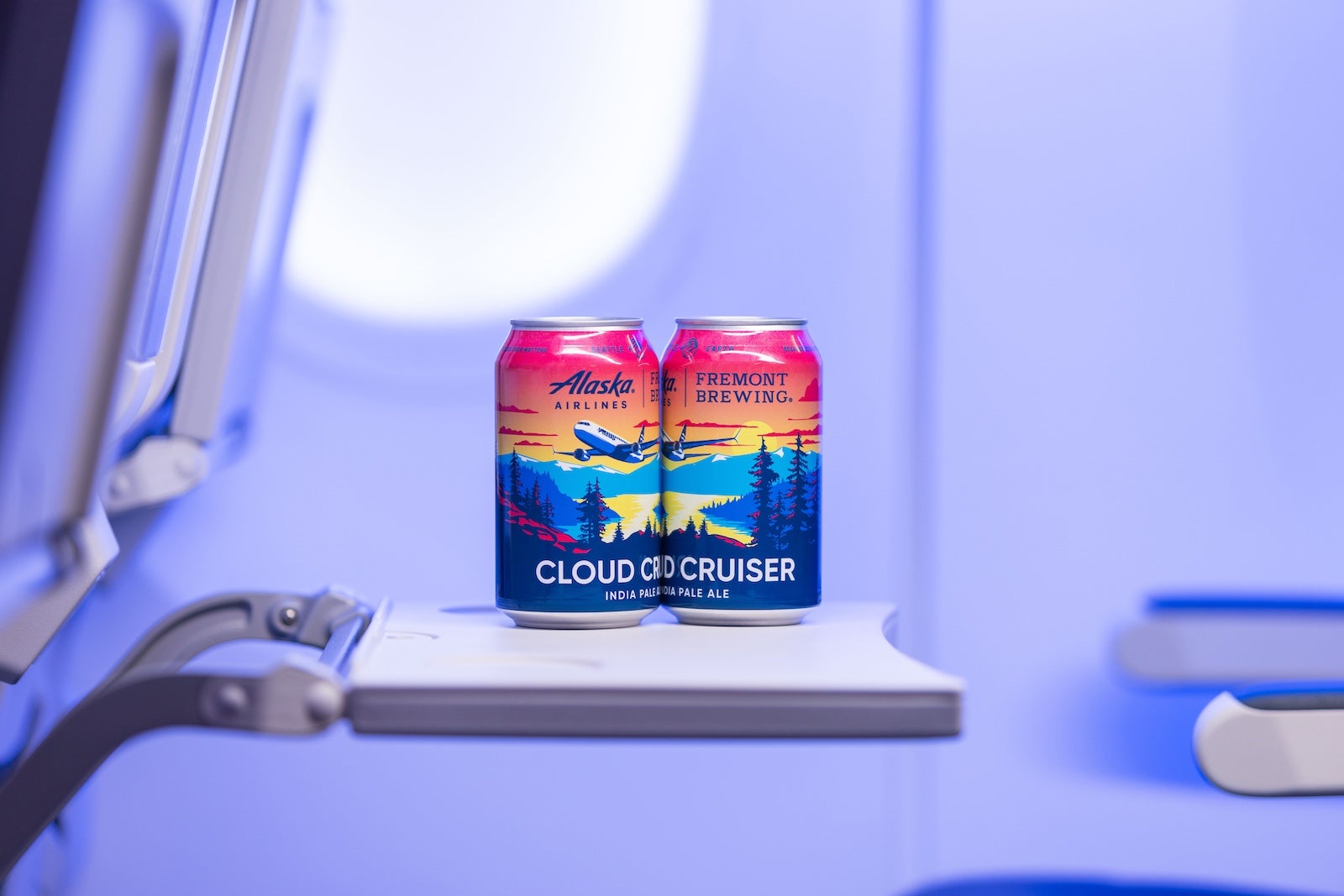 two beer cans on airplane seat tray