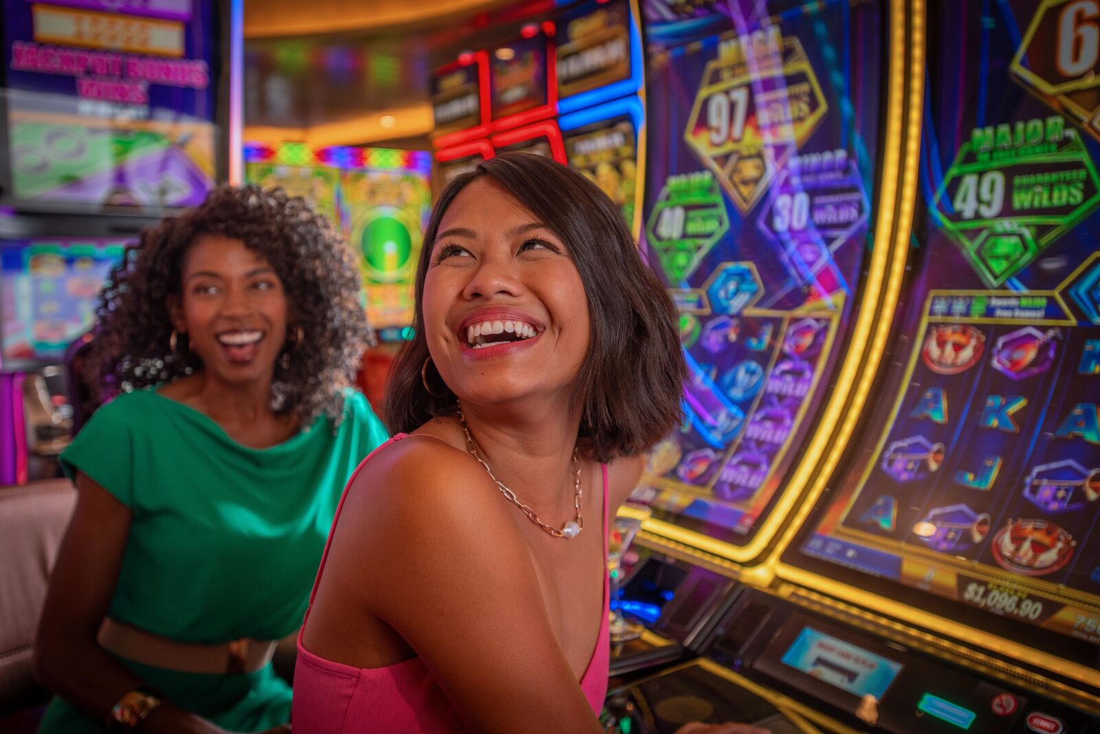 Women playing slot machine at casino on cruise ship