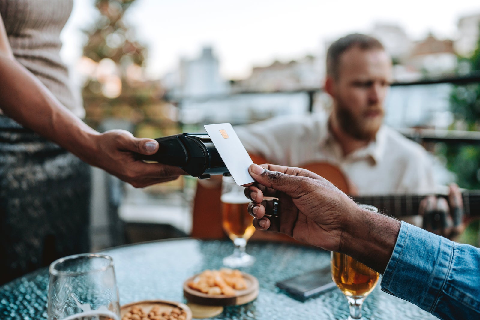 Person using tap to pay at a restaurant