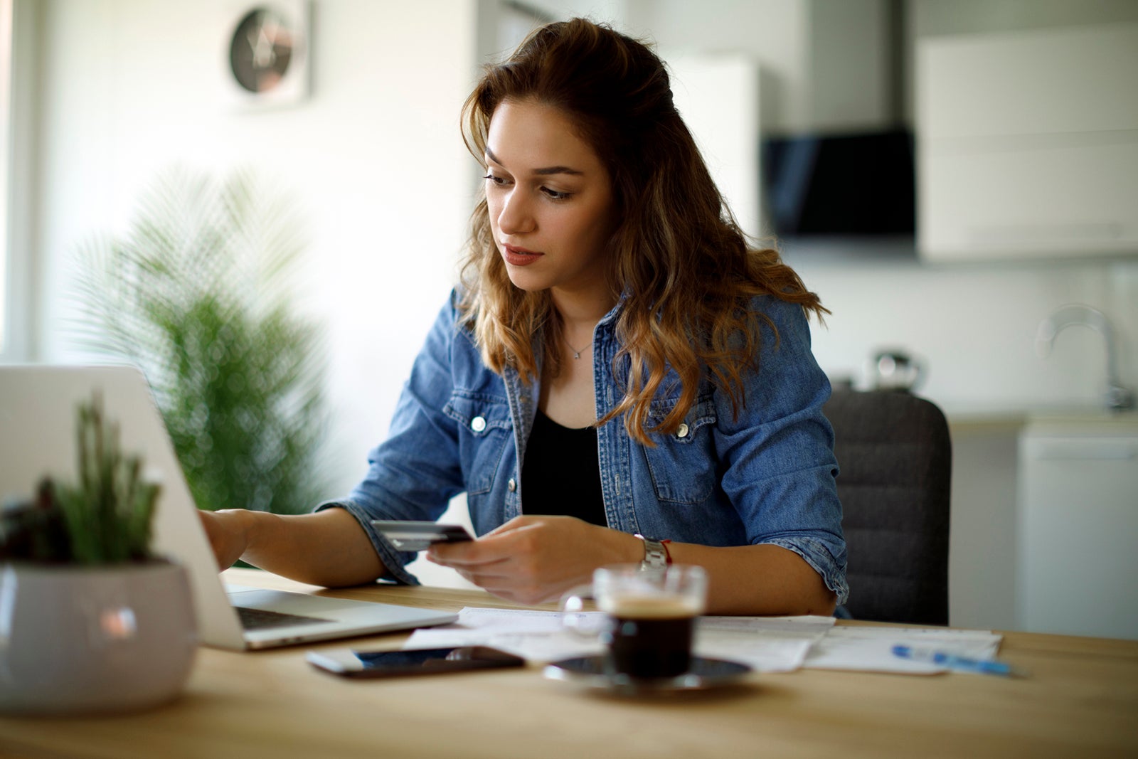 A woman entering in credit card information into a laptop