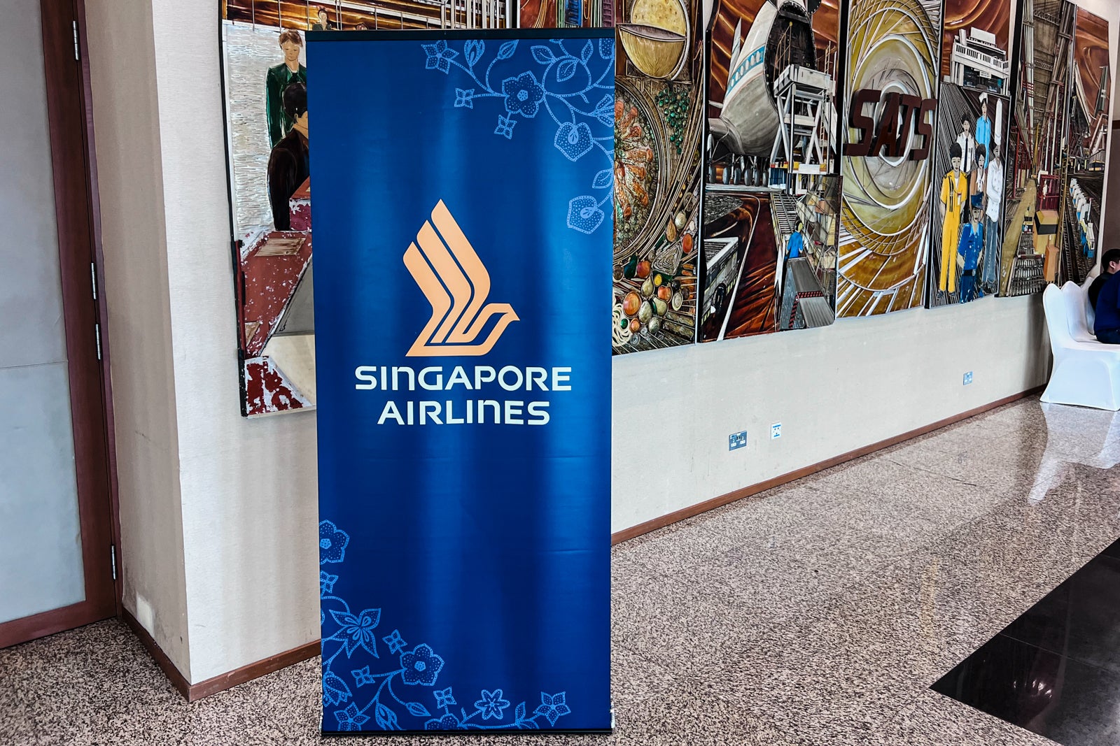 a blue banner with the Singapore Airlines logo
