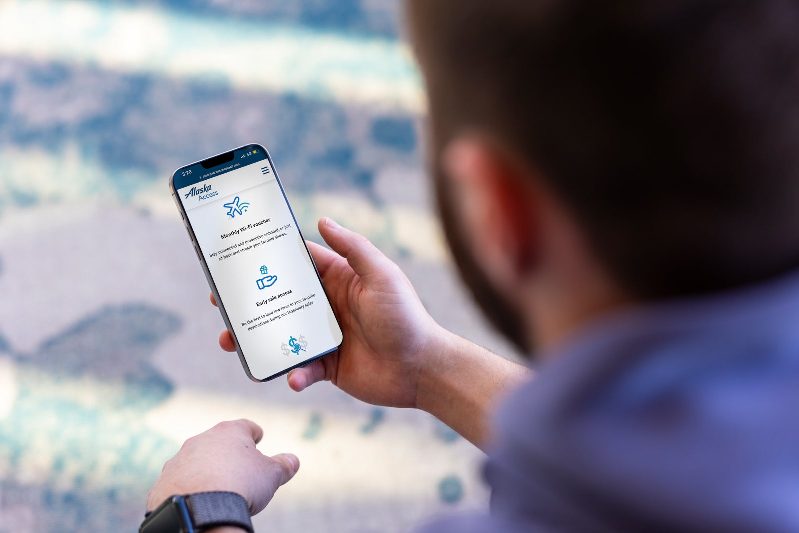 A person using the Alaska Airlines website on their phone