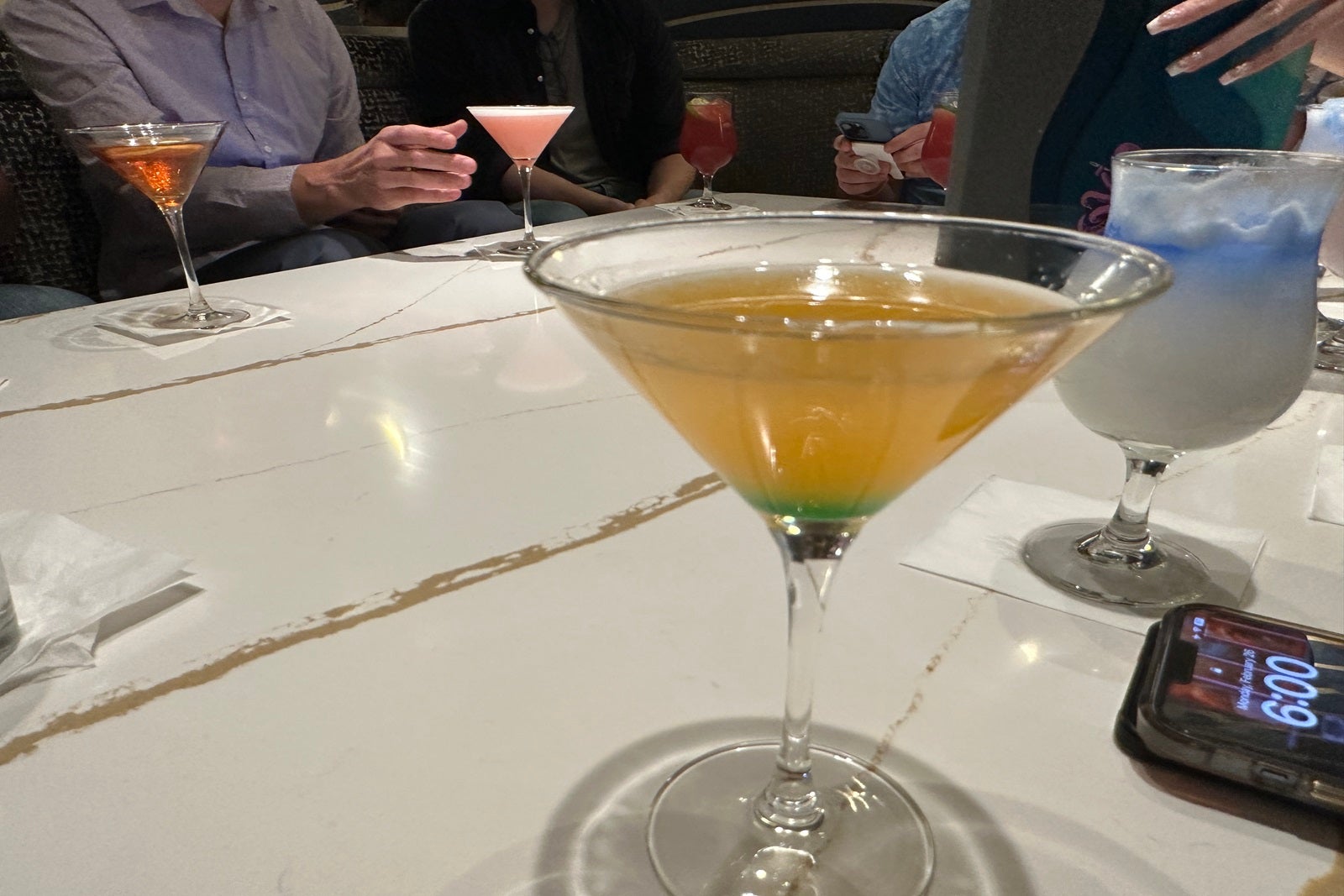 A yellow cocktail in a martini glass