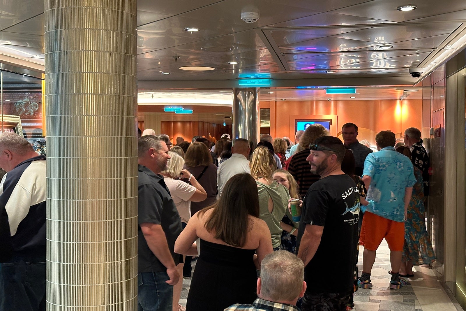 A crowd gathered in a cruise ship corridor