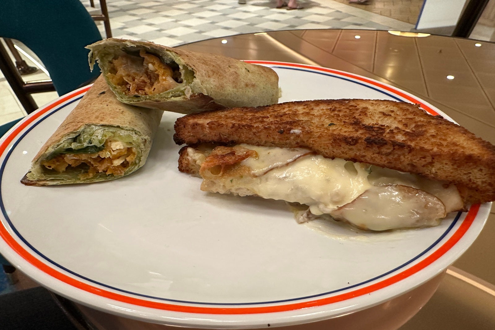 A wrap and a sandwich on a white plate