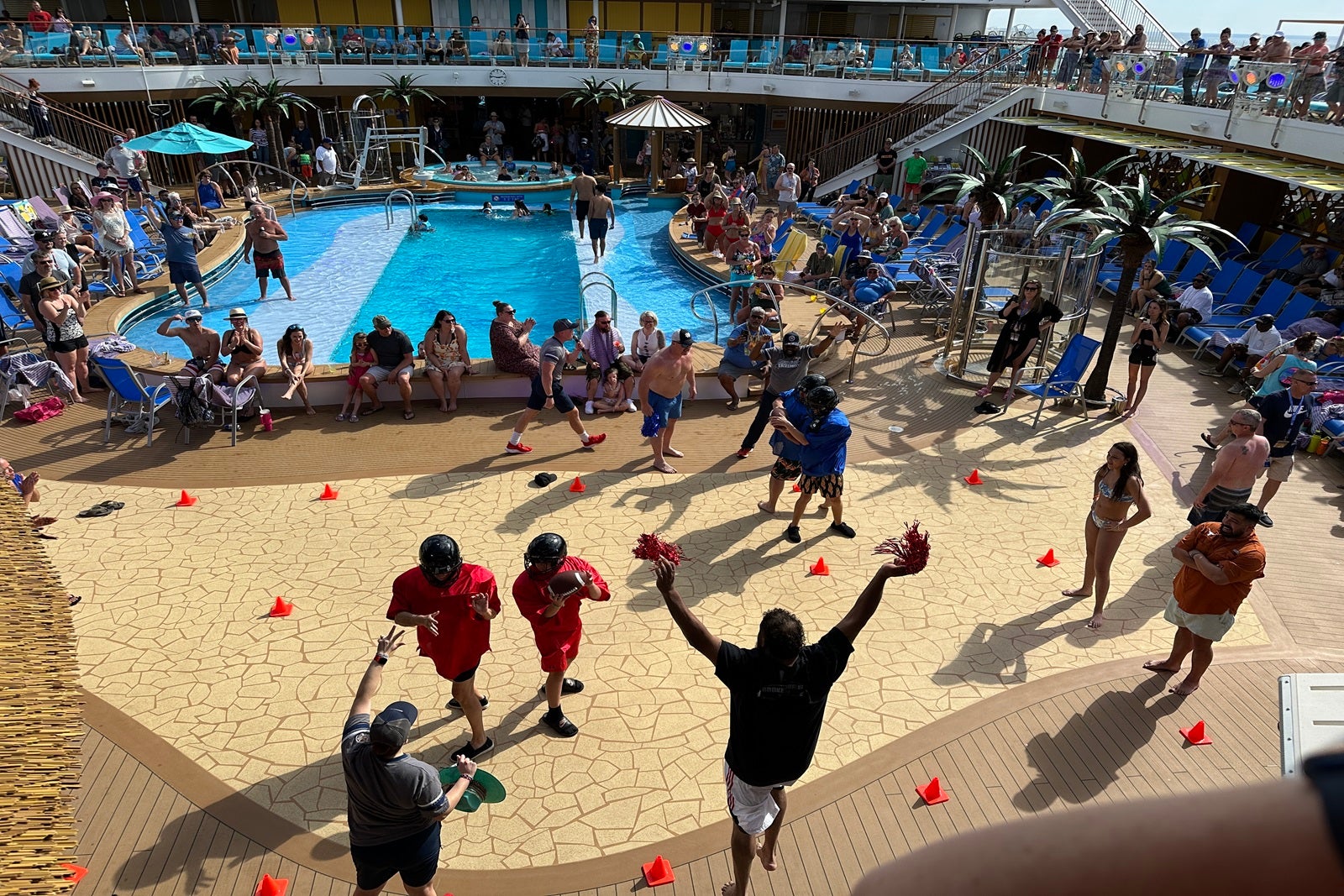 Passengers play football-themed pool deck games