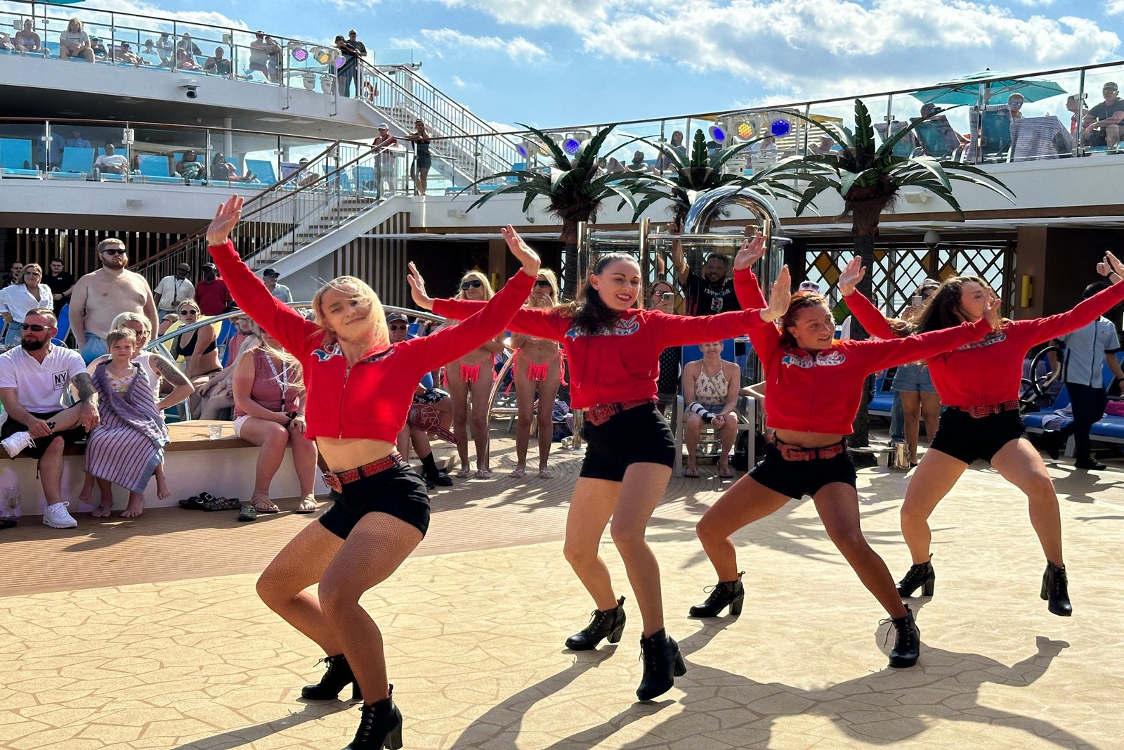 Dancers perform on a cruise ship pool deck