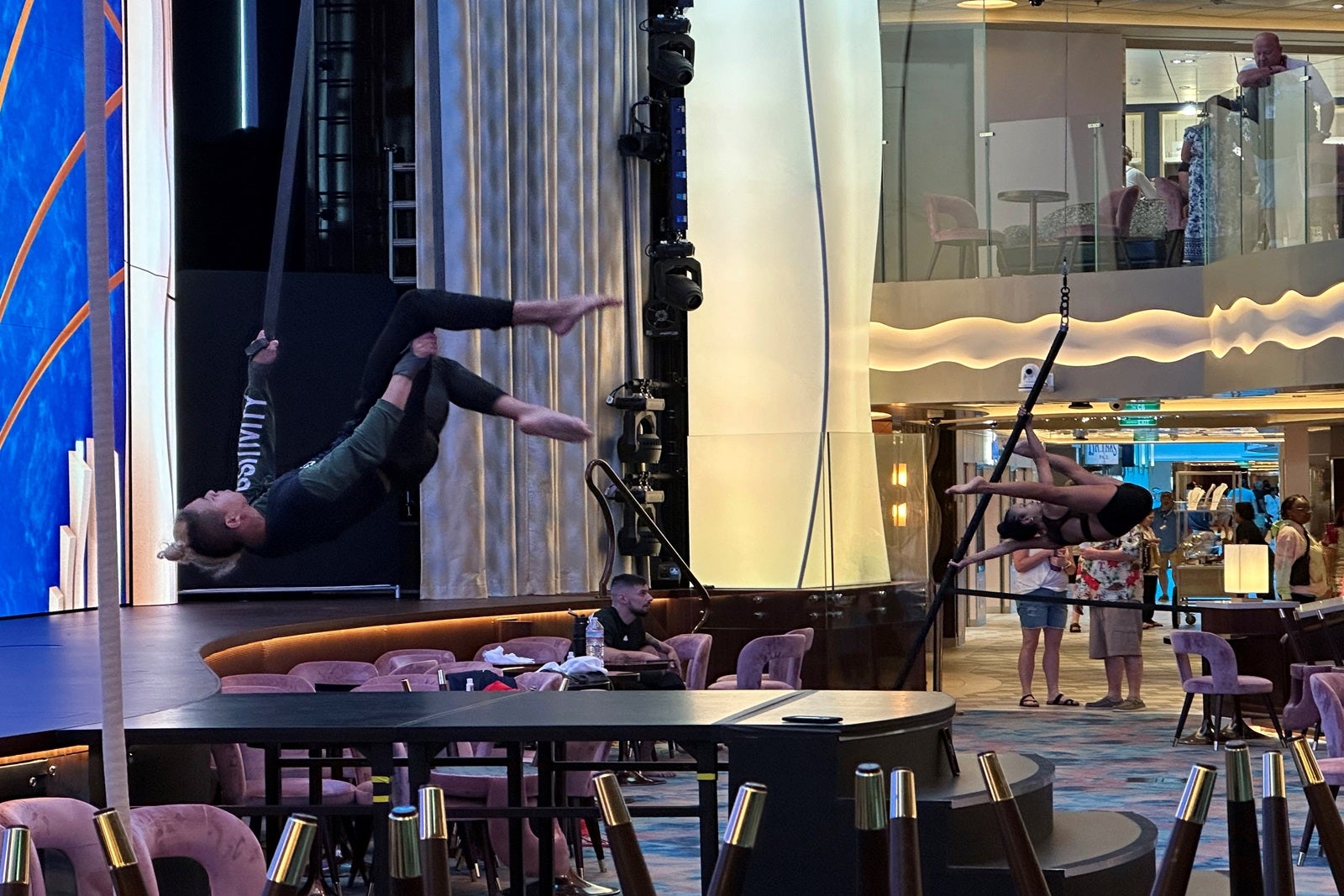 A stage area with acrobats rehearsing while hanging in the air