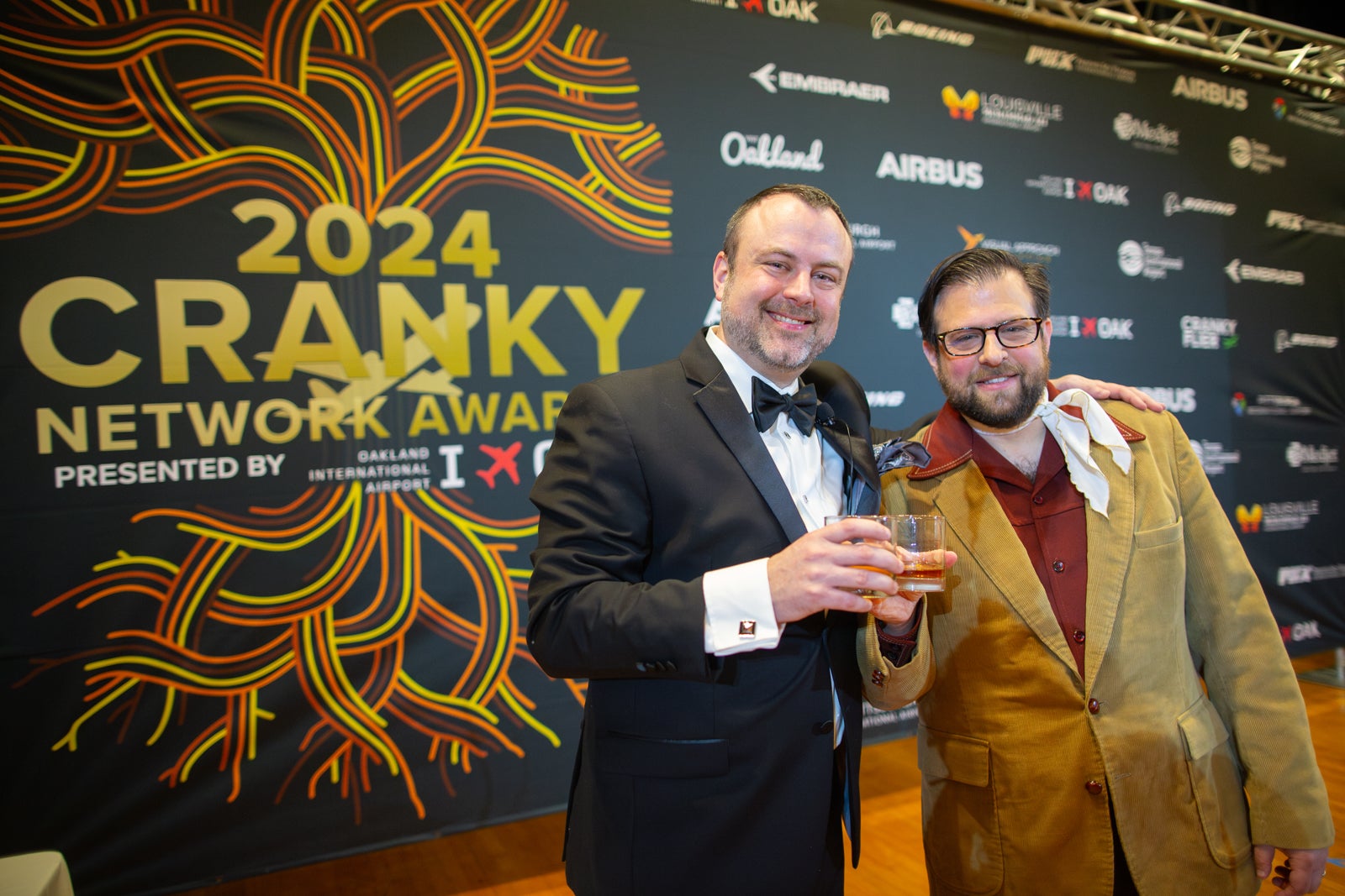 Cranky Flier author Brett Snyder (right) and Courtney Miller of Visual Approach Analytics raise a glass to the 2024 Cranky Network Awards in Oakland. 