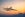 Passenger airplane flying above clouds during sunset