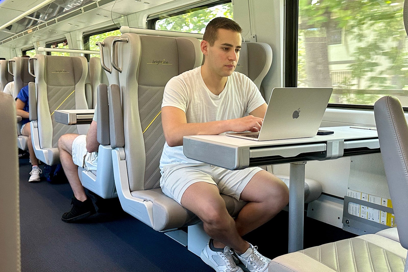 zach using laptop on train