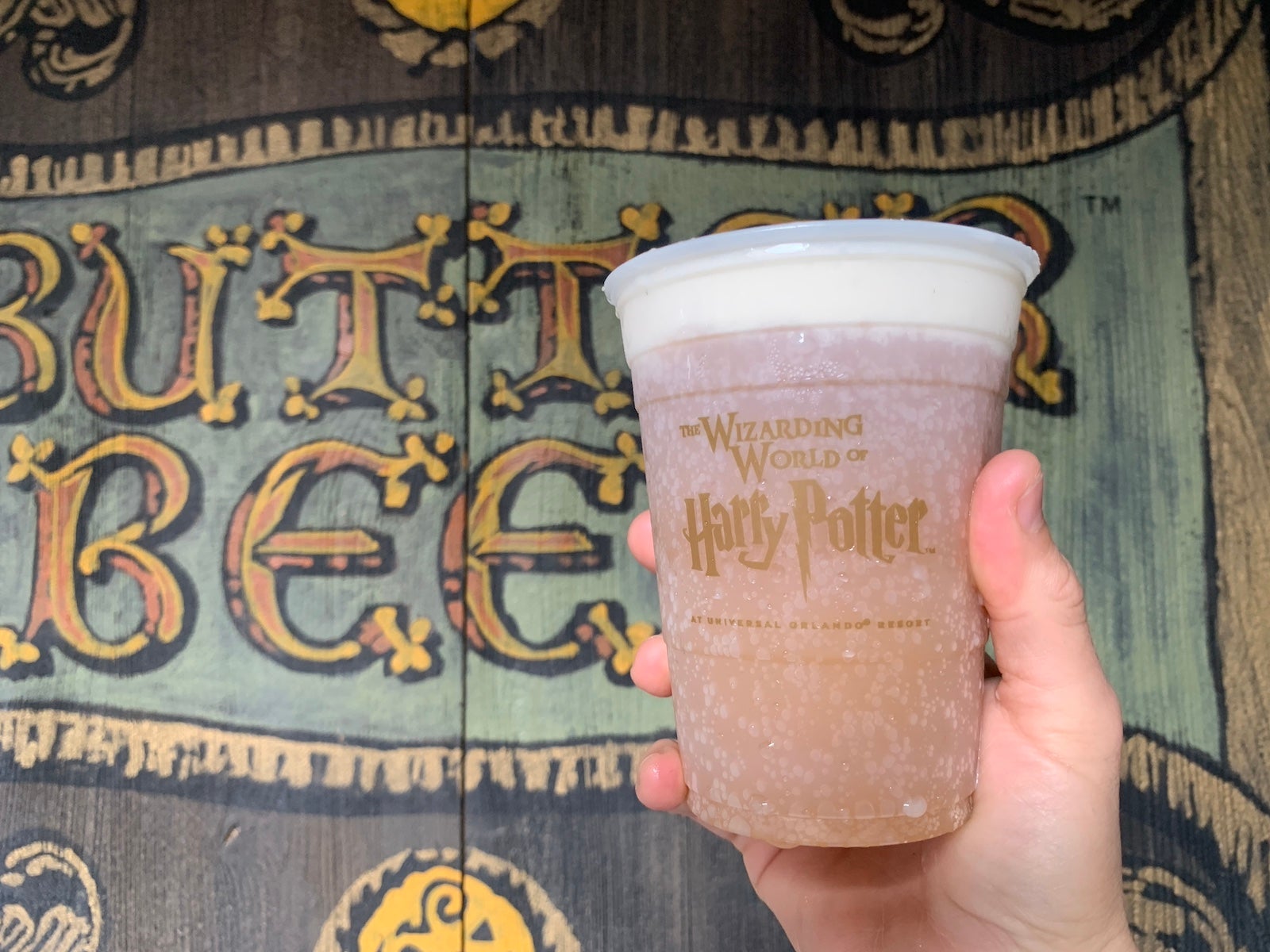 A person holding a butterbeer at the Wizarding World of Harry Potter