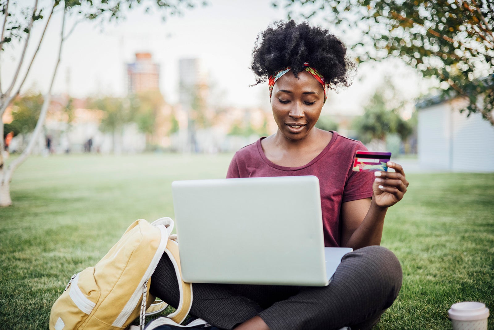 Young woman sitting in a park using a laptop