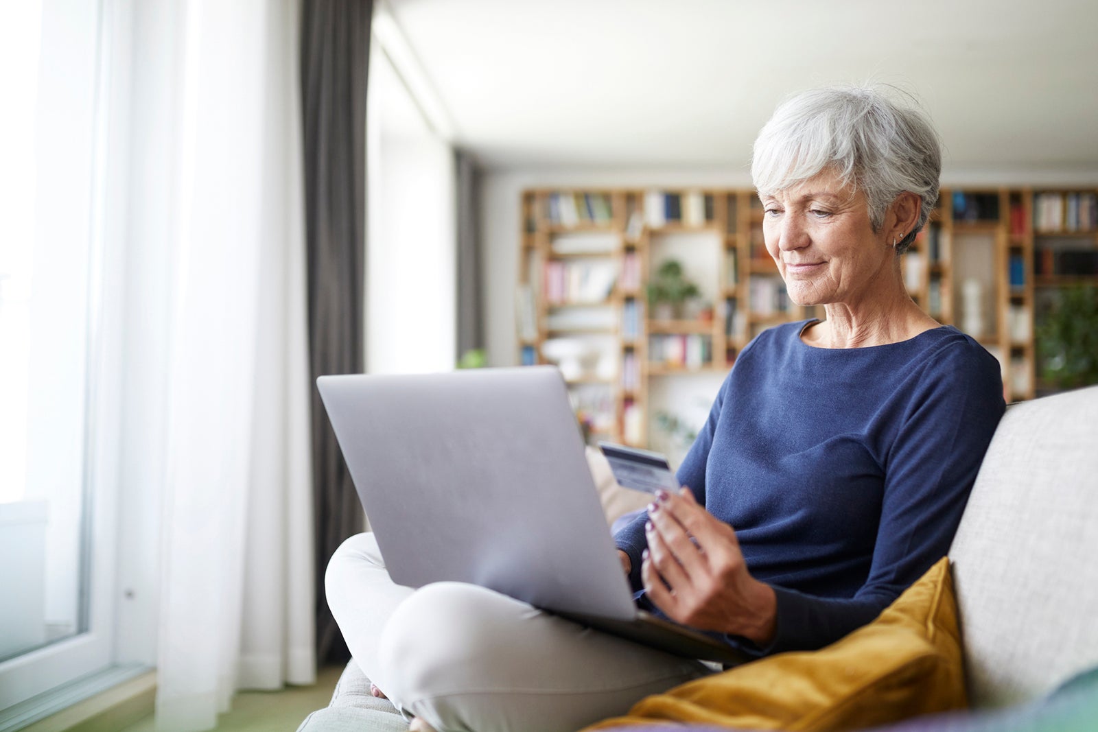 Woman using credit card to shop online