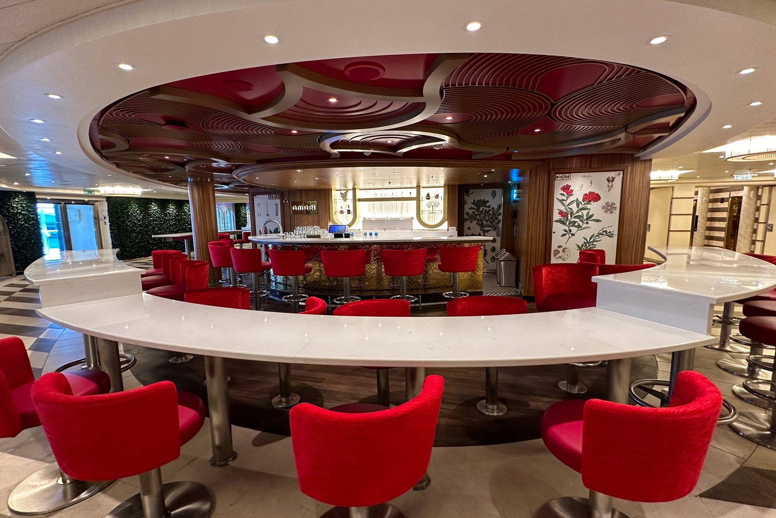 A round bar with red chairs on a cruise ship