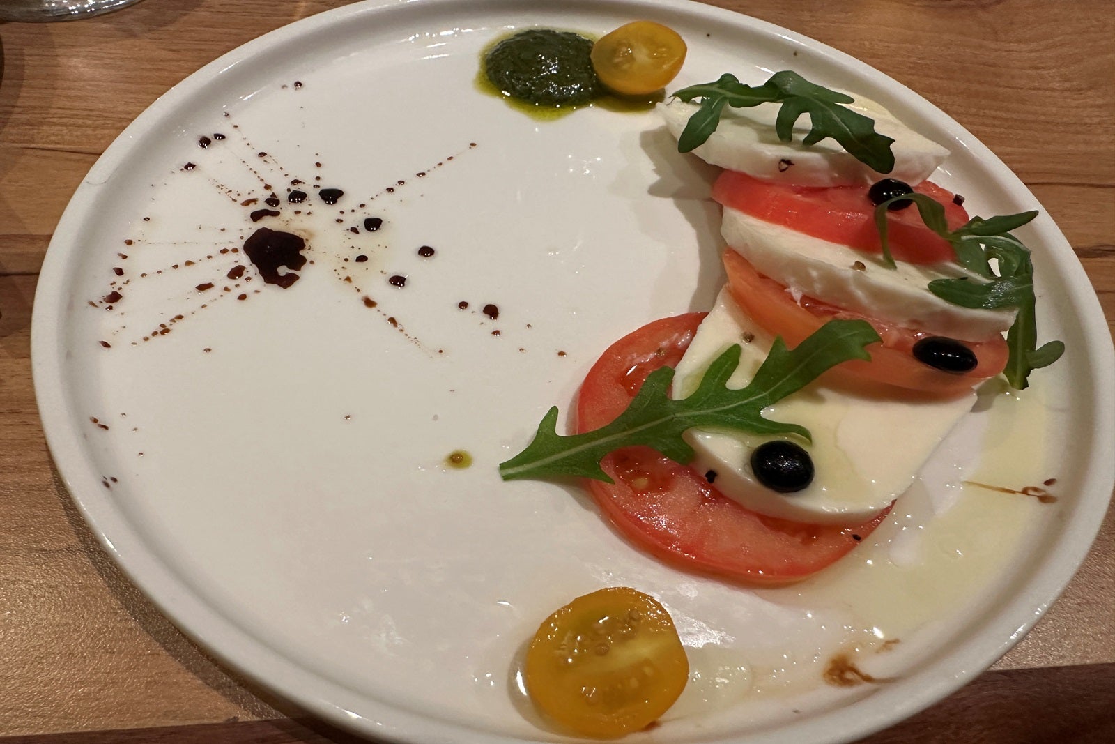 A plate with decoratively arranged caprese salad