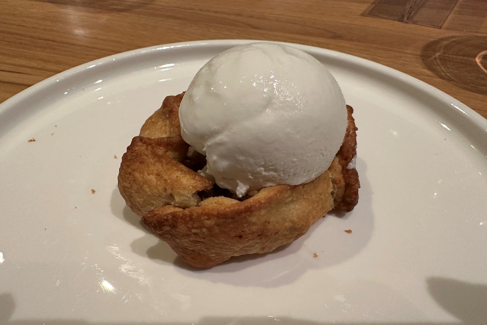 An apple pastry with a scoop of ice cream on top