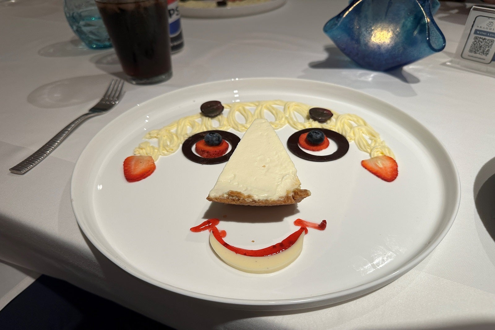 Dessert laid out to look like a face on a white plate