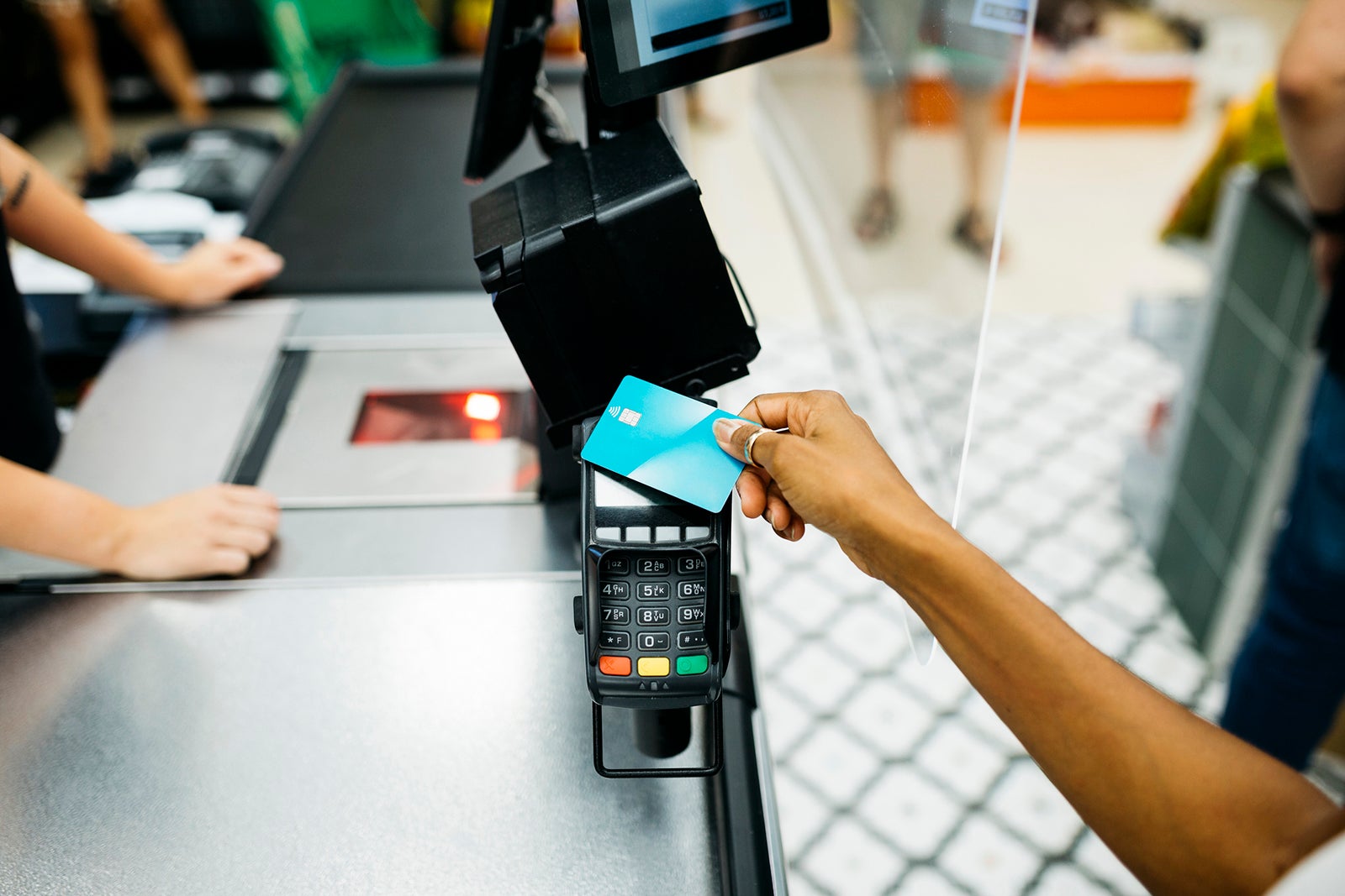 a customer pays touches their credit card to a point of sale machine