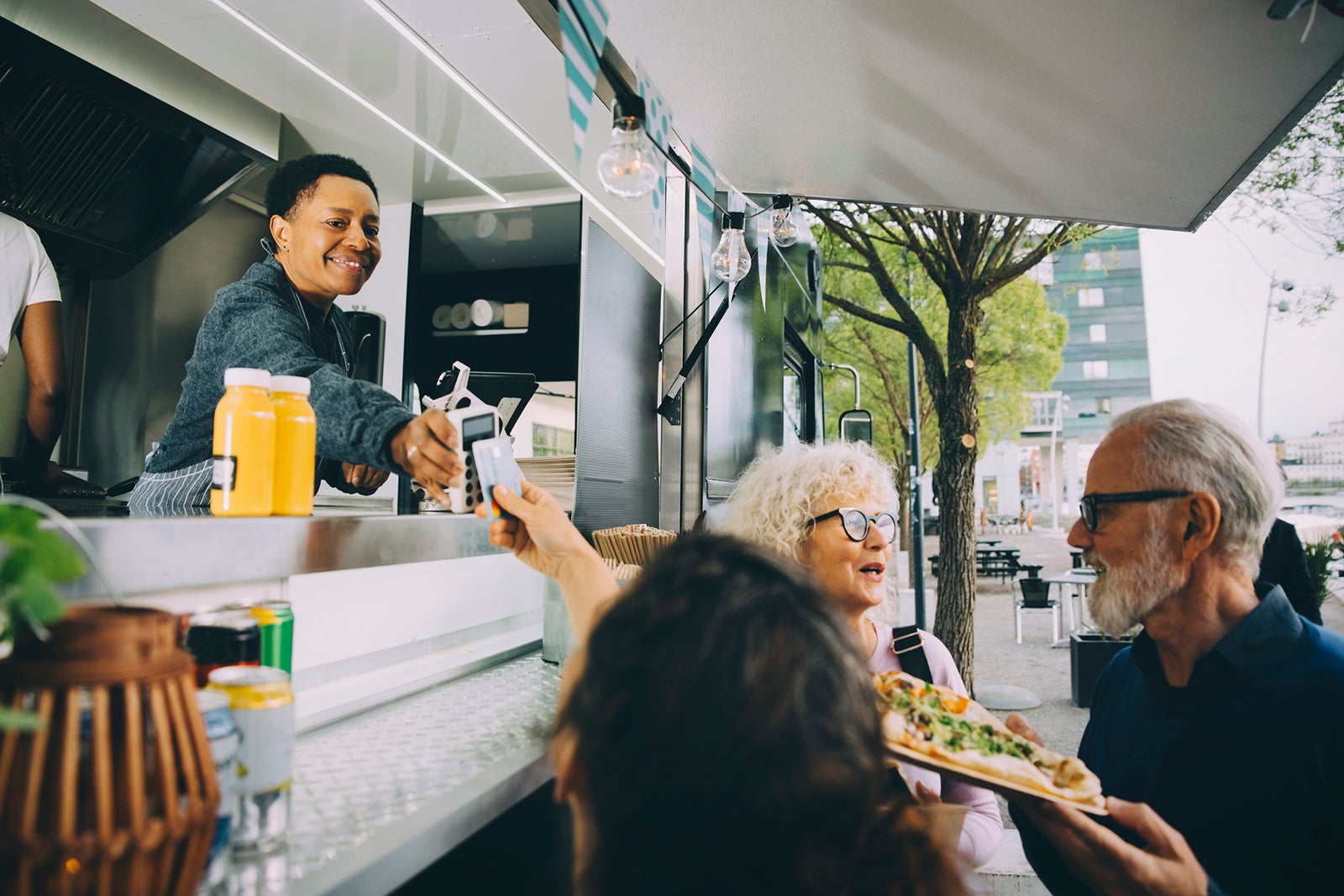 Woman paying with a card at a food truck