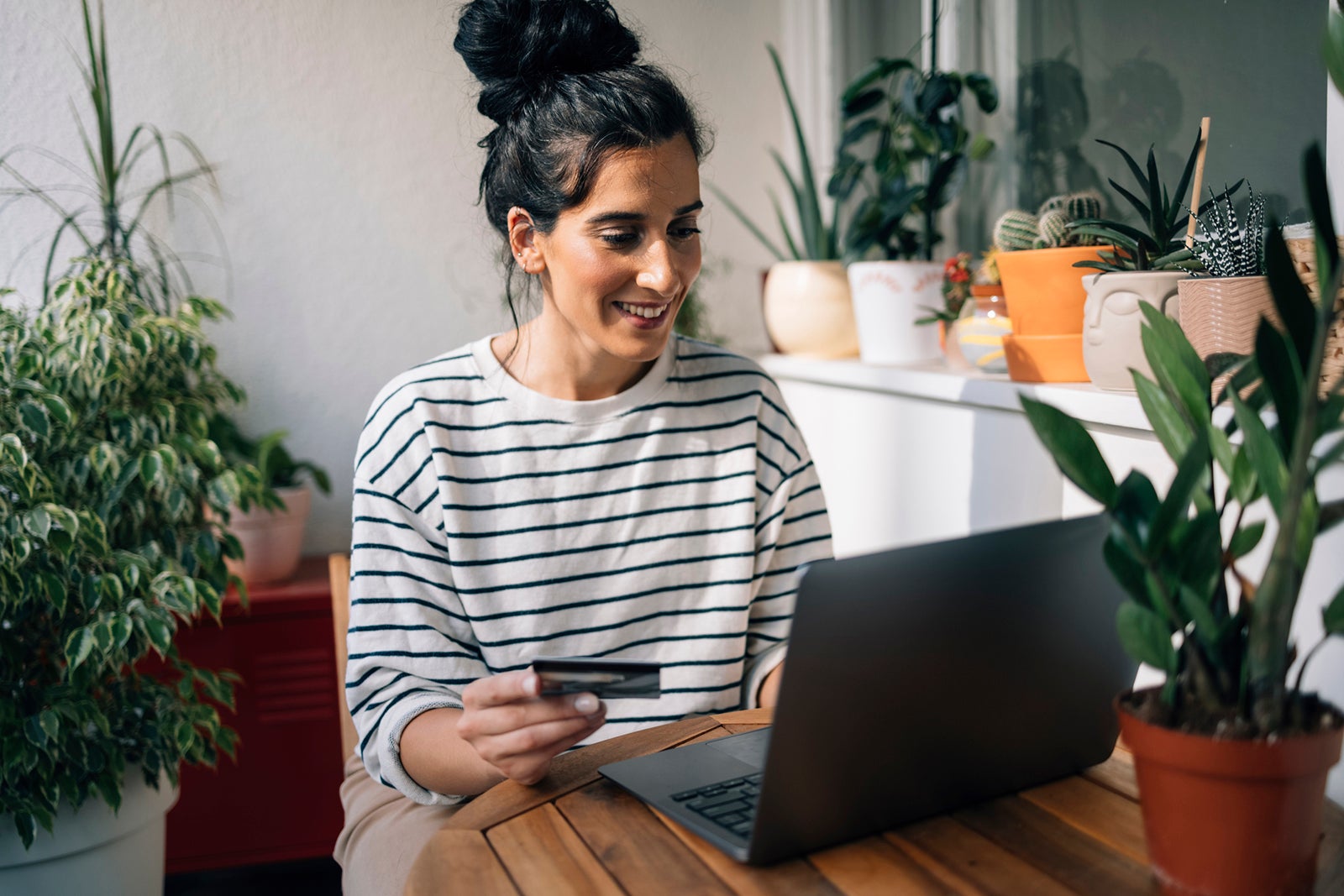 Woman using a credit card at her desk