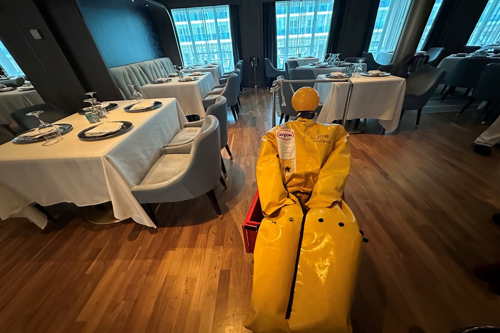 A fire rescue dummy waits in a cruise ship restaurant to be saved during a crew drill
