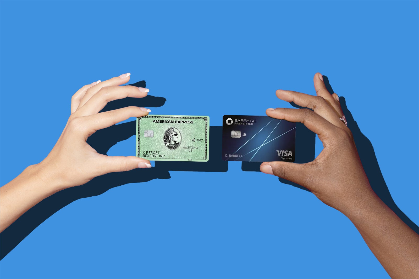 Two people holding an Amex Green card and a Chase Sapphire card