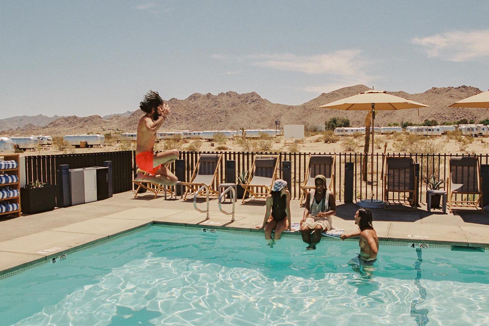 People enjoying the pool at Autocamp Joshua Tree