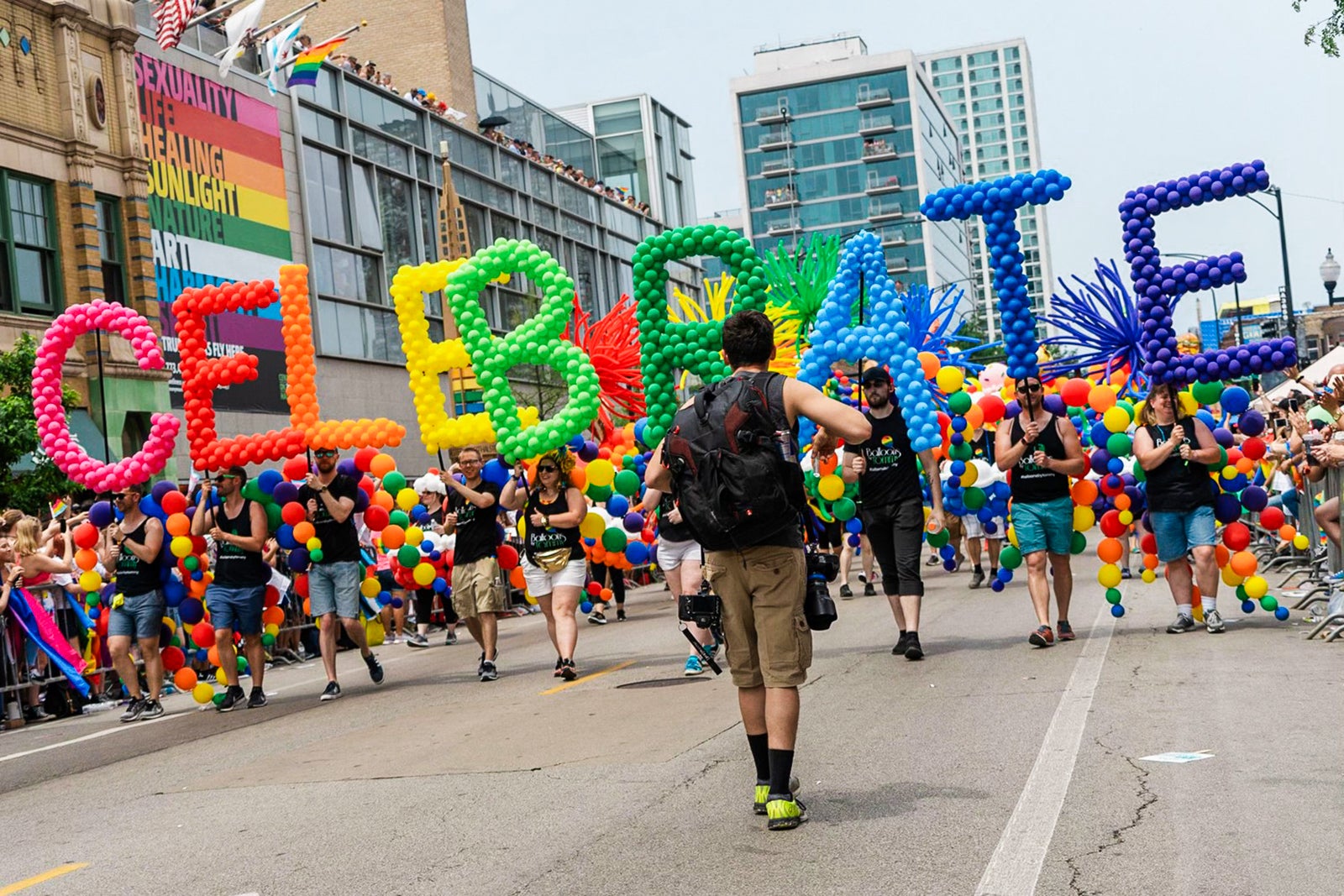 balloons spelling CELEBRATE in Chicago pride march