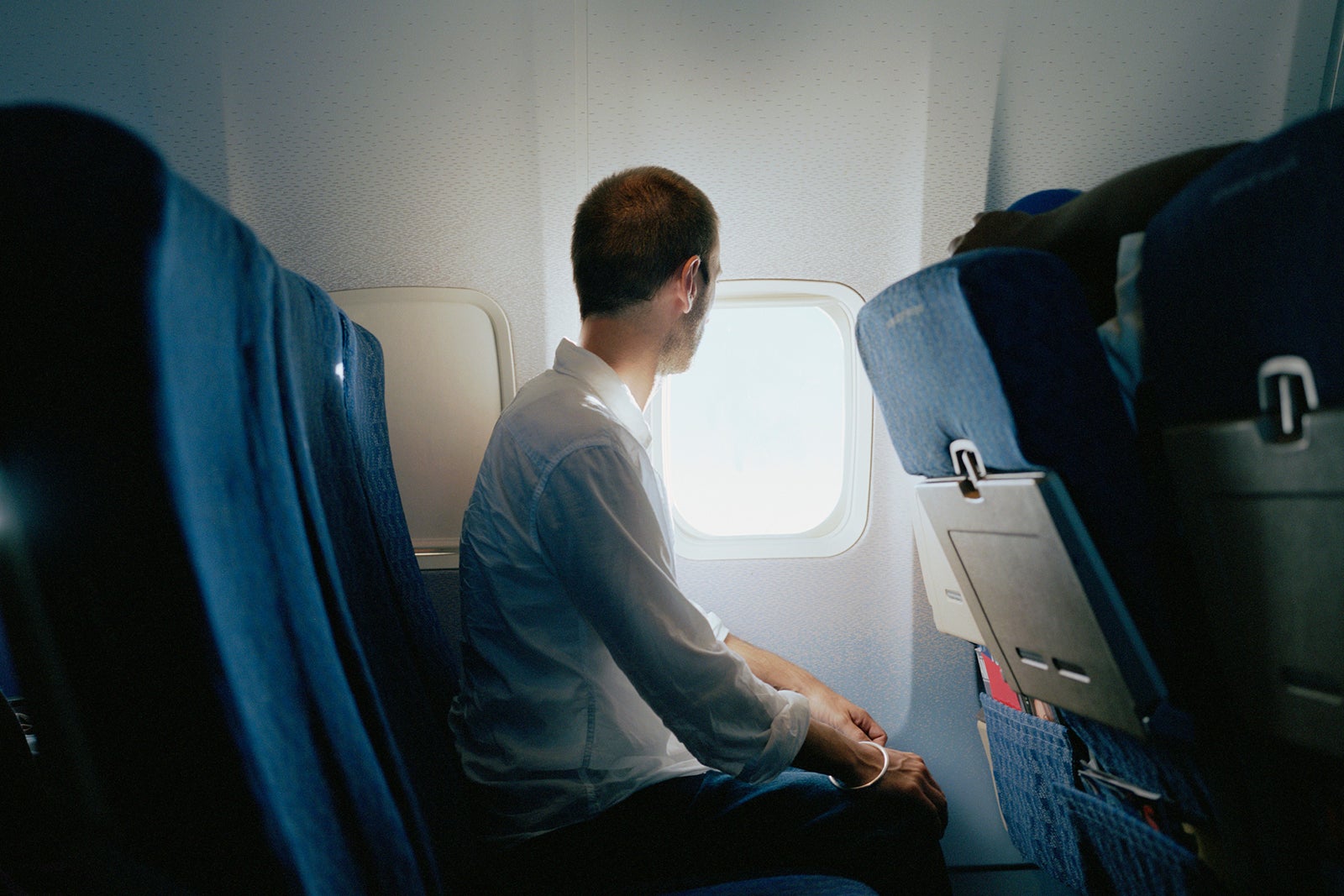 A person looking out the window of a plane