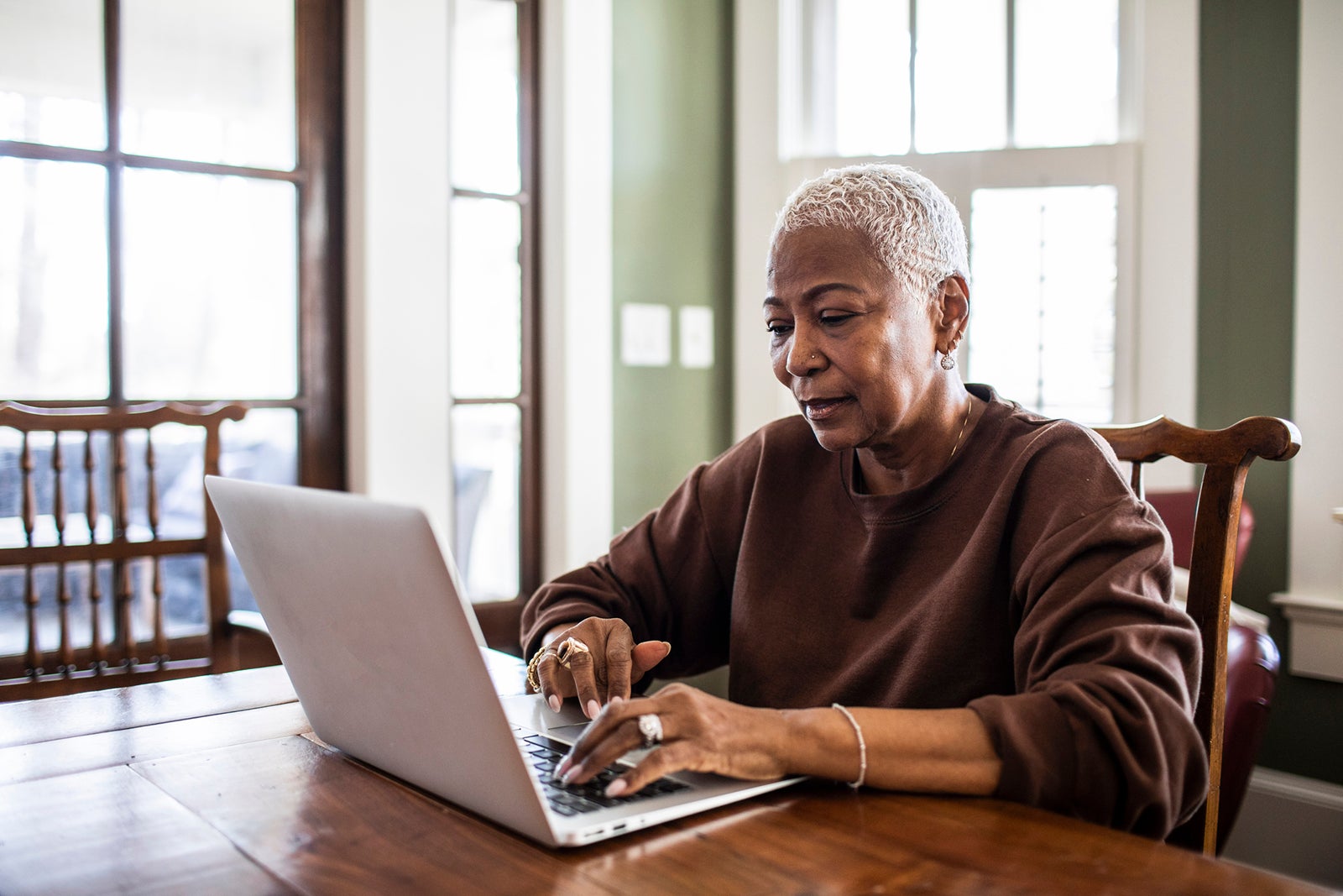 Senior woman using laptop at home