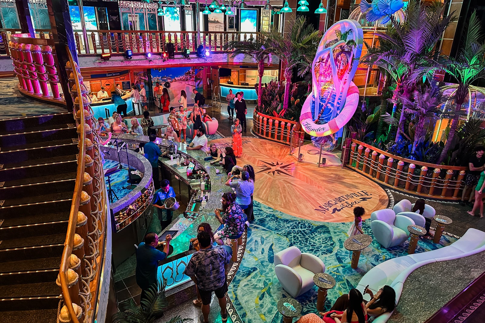 The colorful atrium on Margaritaville at Sea's Islander cruise ship