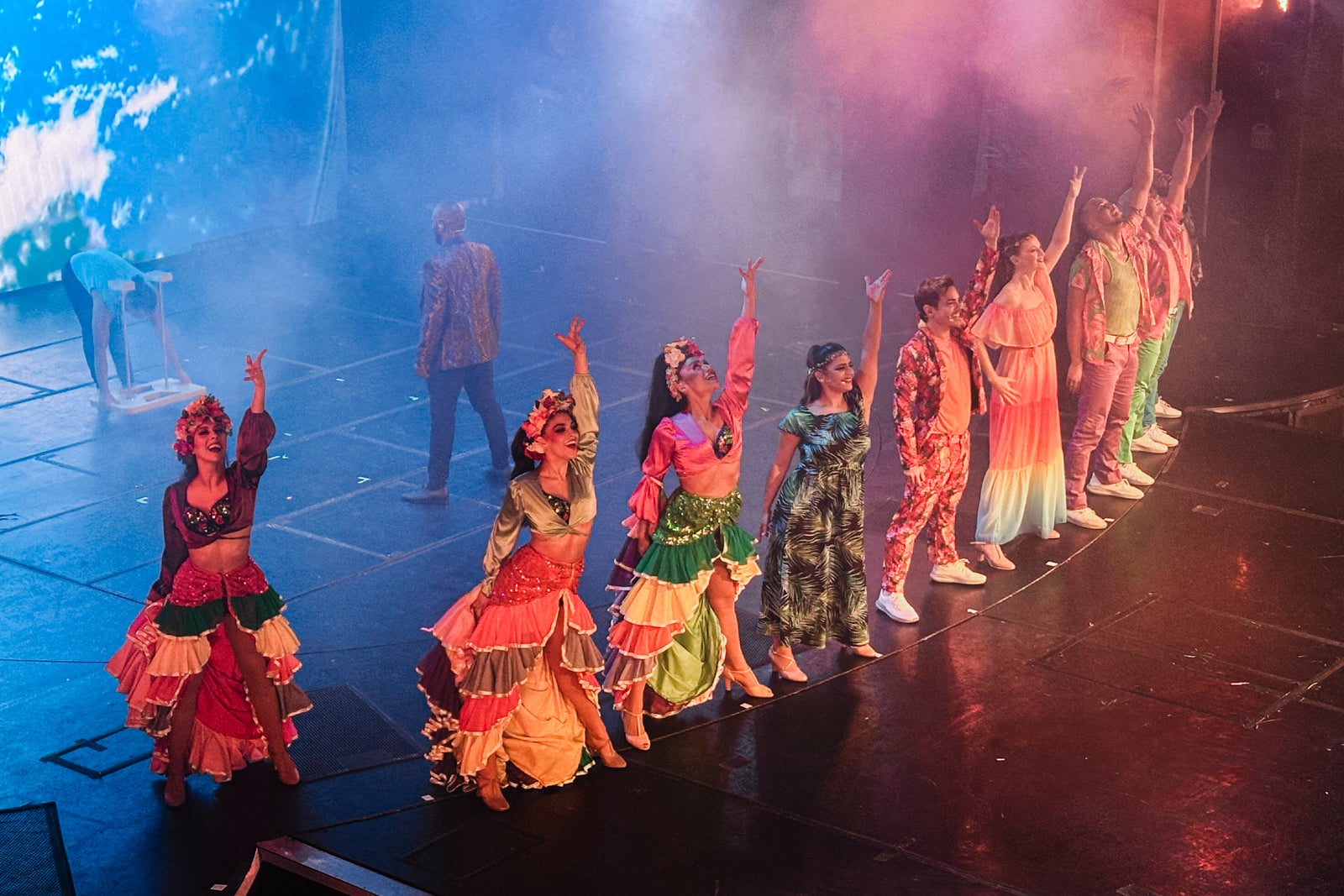 Performers finishing a dance number on a theater stage on a cruise ship