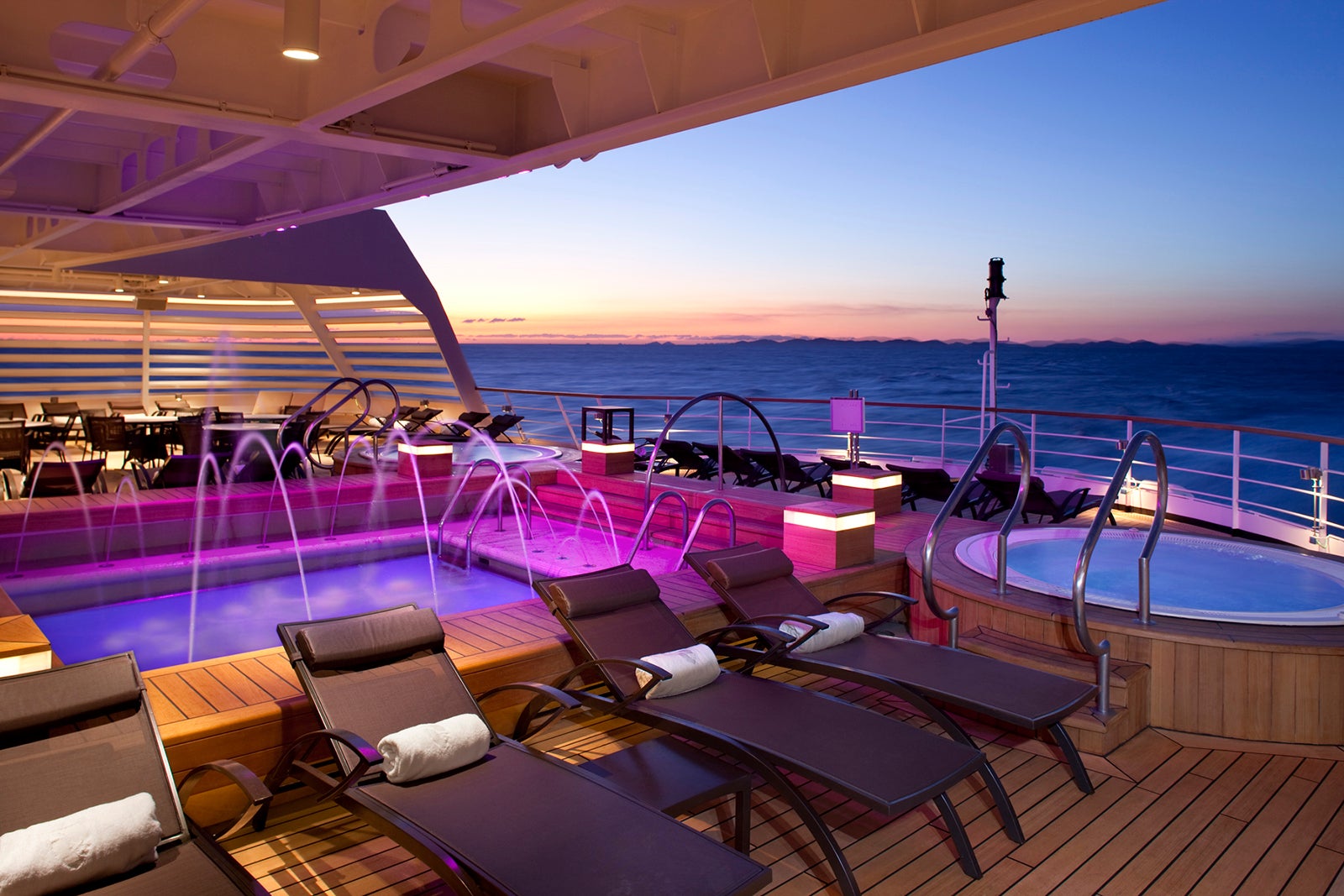 Aft pool of cruise ship at sunset