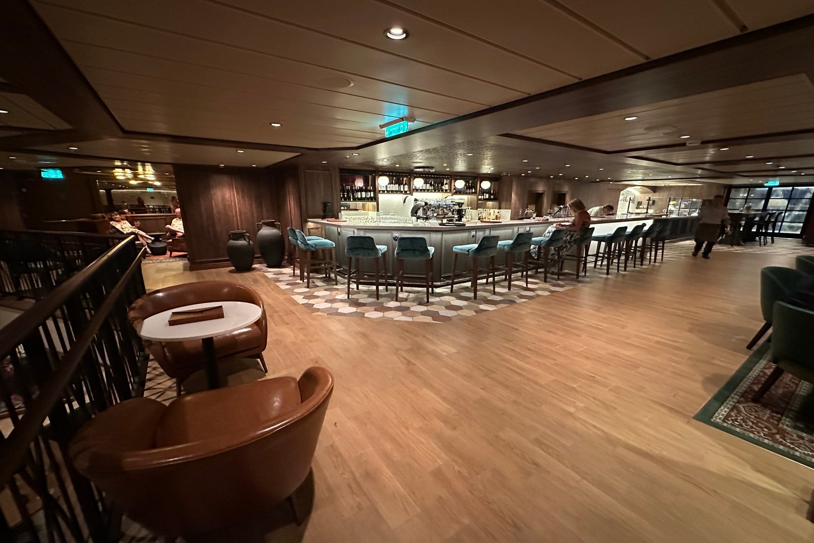 A cruise ship wine bar with surrounding tables and chairs