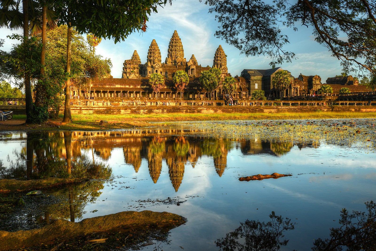 landscape view of Angkor Wat temples with lake in front