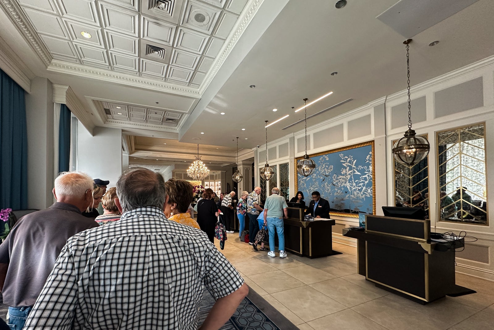 A line of people waiting to check in at a hotel