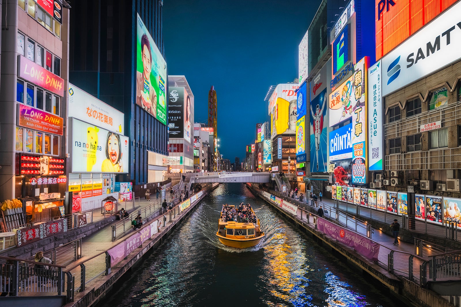 tourist boat cruising Dotonbori canal in Osaka at night