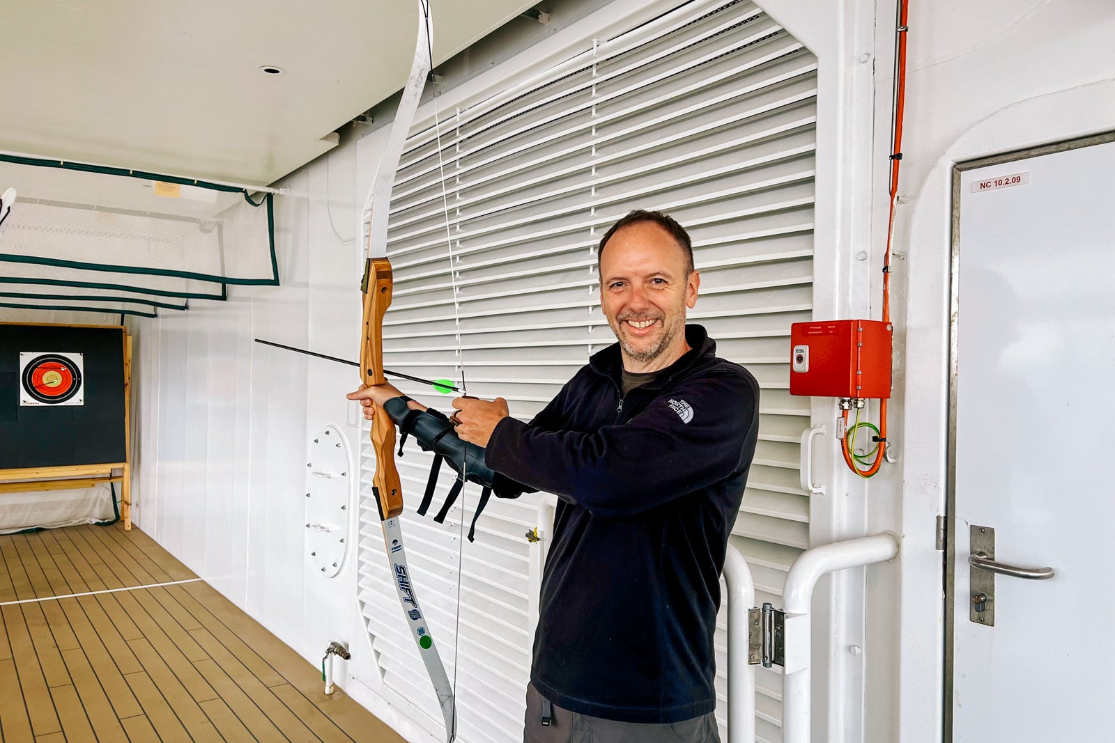 TPG's Gene Sloan tries his hand at archery on Queen Anne. 