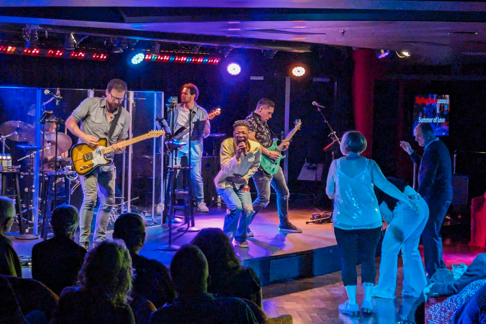 Singer and band on stage in cruise ship nightclub