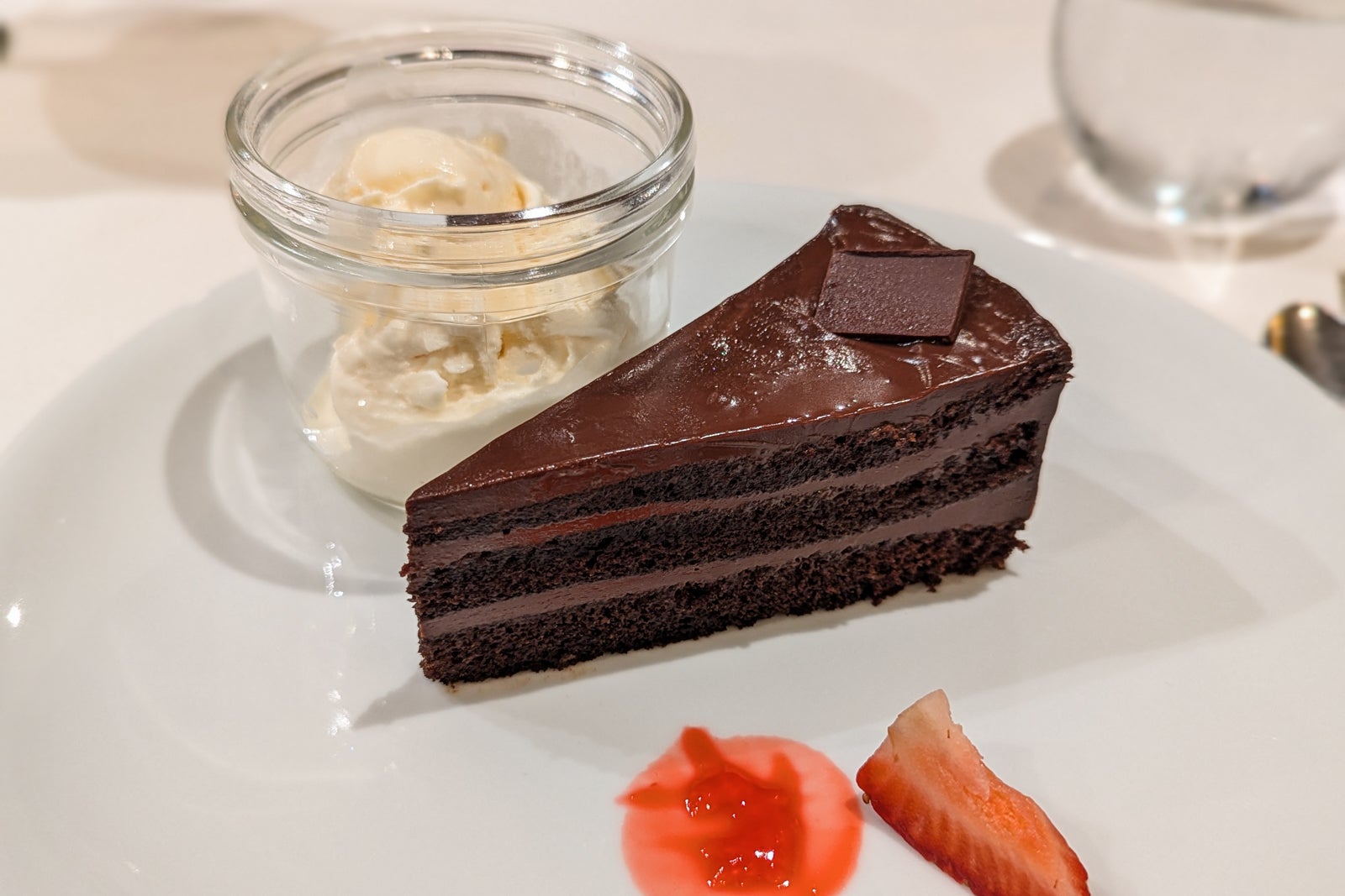 Chocolate cake with a glass bowl of ice cream 