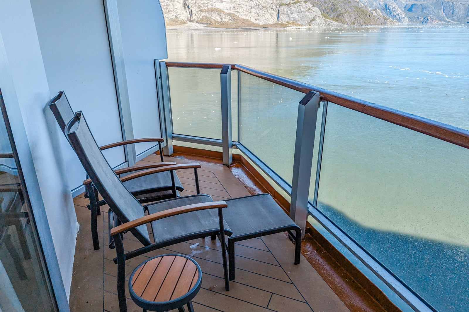 Eurodam cabin balcony with two chairs with drinks table and footrests