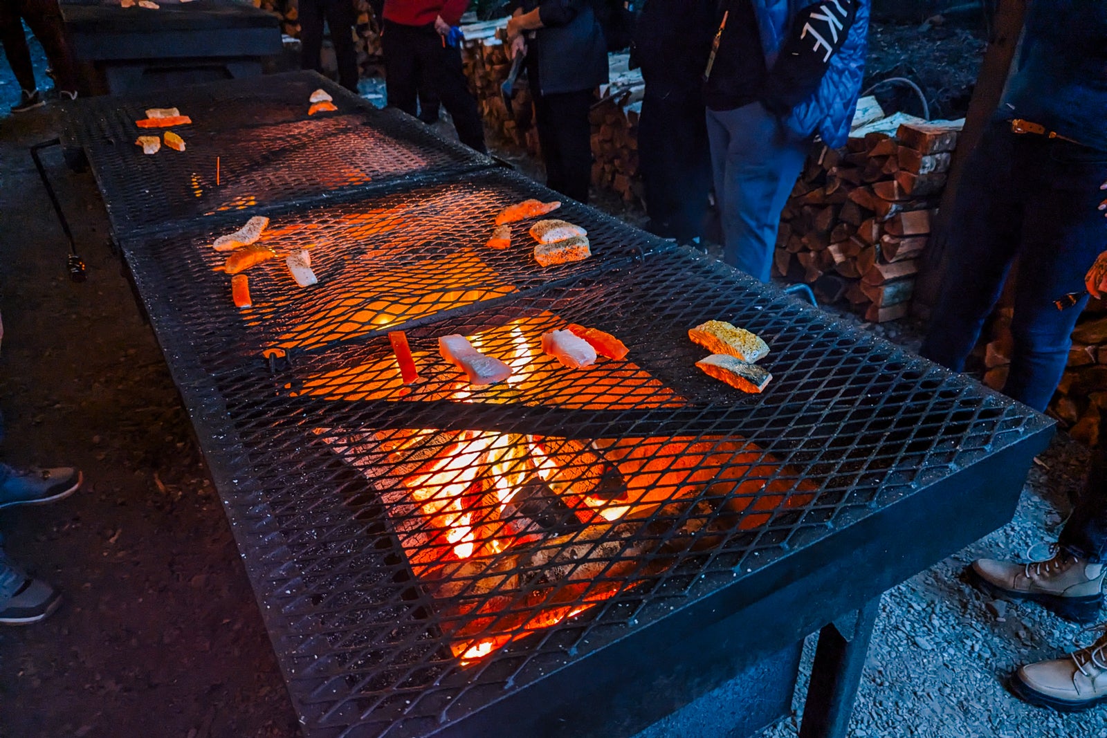 Salmon and halibut cooking over a grill