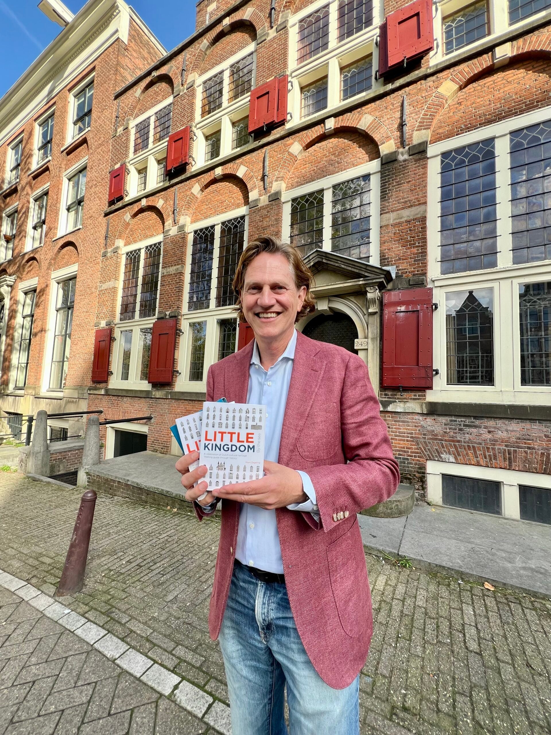 Author Mark Zegeling in front of the House on Three Canals